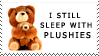 stuffed bear with text saying I still sleep with plushies